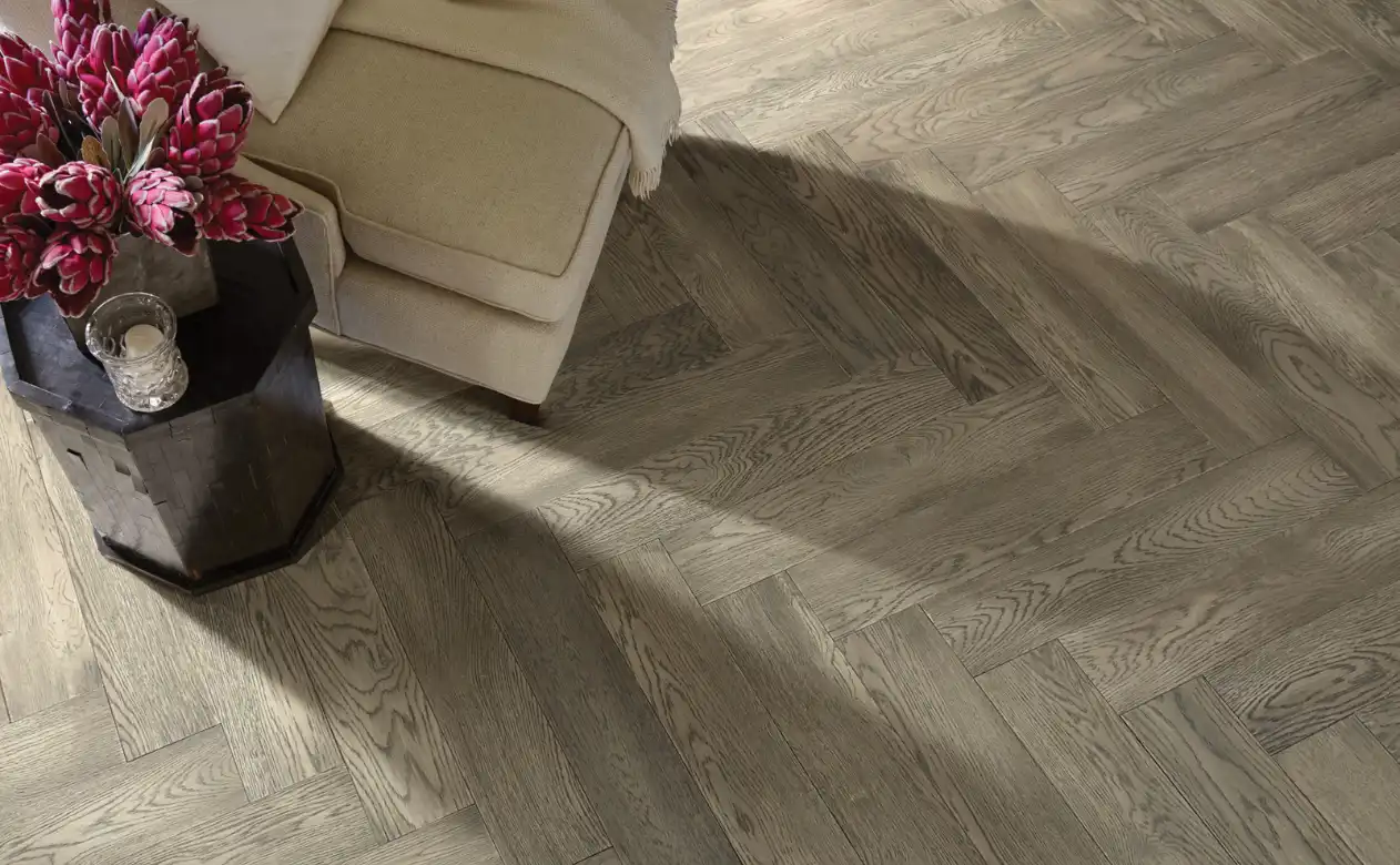herringbone hardwood floor with cream colored chair 